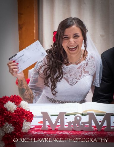 Smiling bride holding an envelope, surrounded by flowers and "M&M" letters.